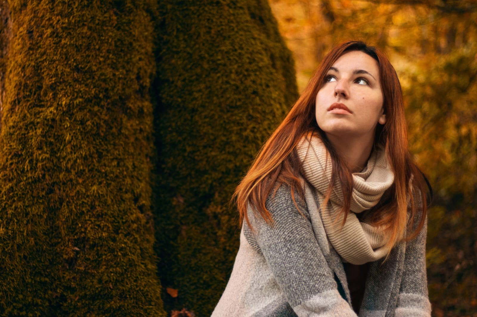 Person reflecting on personal growth in natural environment